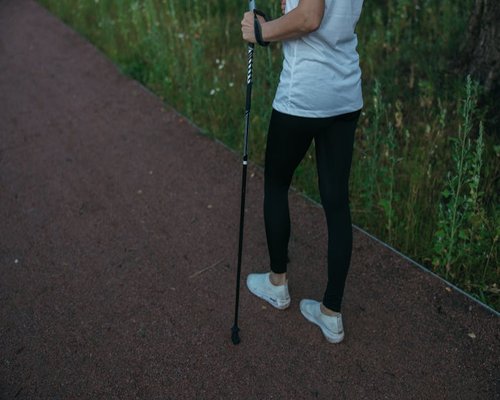 Person walking mindfully on a calm nature trail