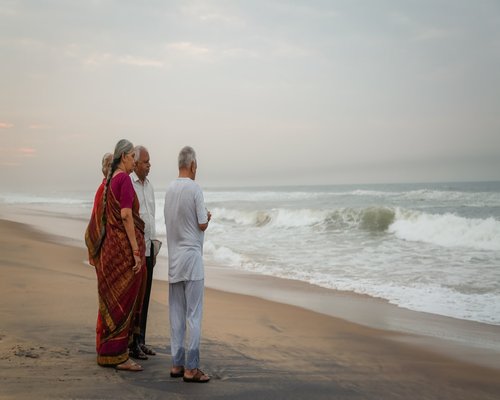 Happy Indian family chatting while walking outdoors in the evening